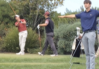 Max McGreevy of Oklahoma tees off on No. 8 <br>while a concerned Ollie Schniederjans of Georgia Tech<br>signals ahead to see if his own tee shot is safe