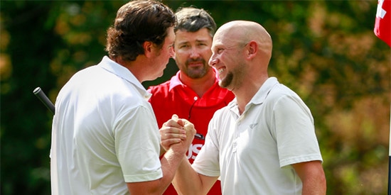 Jason Anthony (R) is congratulated by four-time champion Nathan Smith (L)<br>(USGA photo)