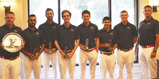 The Saint Mary's men's golf team accepting the trophy as the rain fell outside<br>(St. Mary's photo)