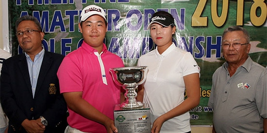 Tom Kim and Hwang Min-jeong (center) got their hands on the trophy in different ways<br>(National Golf Association of the Philippines photo)
