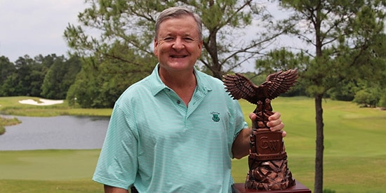 Mike Booker holds the trophy for the 4th time (CWI photo)