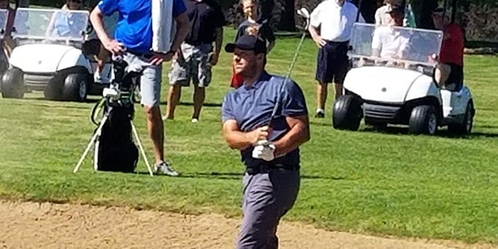 Tony Romo blasts out of a bunker at Meadowbrook CC (Journal Times photo)