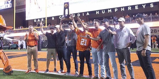 Showing off last year's national championship trophy (OkSt Athletics photo)
