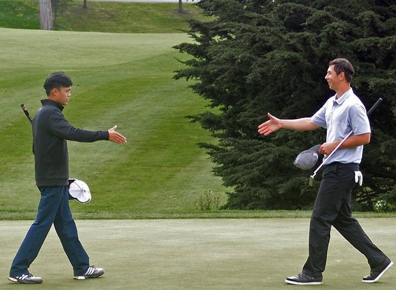 Champion Brian Ma (left) accepts congratulations from<br>runner-up Seb Crookall-Nixon at Harding Park