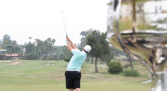 With the trophy behind him, Bobby Bucey tees off this morning