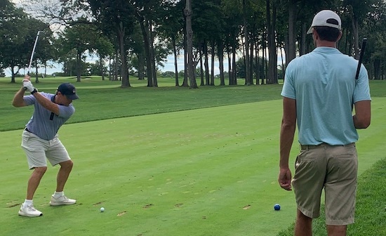 Mike McBride of Deepdale takes a mighty lash, as partner<br>3-time Walker Cup player Stewart Hagestad looks on