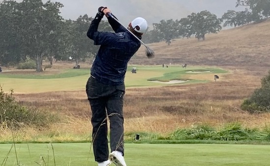 What a difference a day makes:<br>Michael Davis tees off in steady rain on Friday
