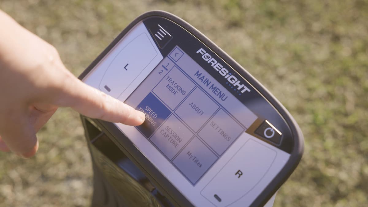 Golfer using the Foresight QuadMAX touchscreen display