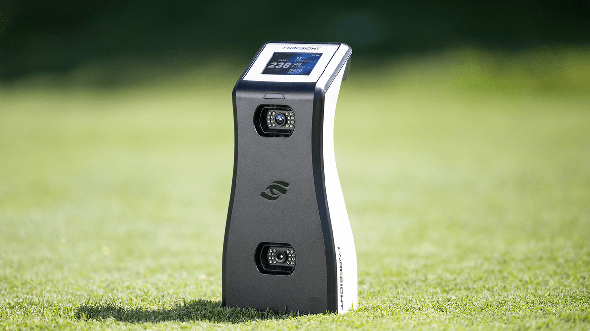 Foresight GC2 launch monitor with color display set up on grass for outdoor practice