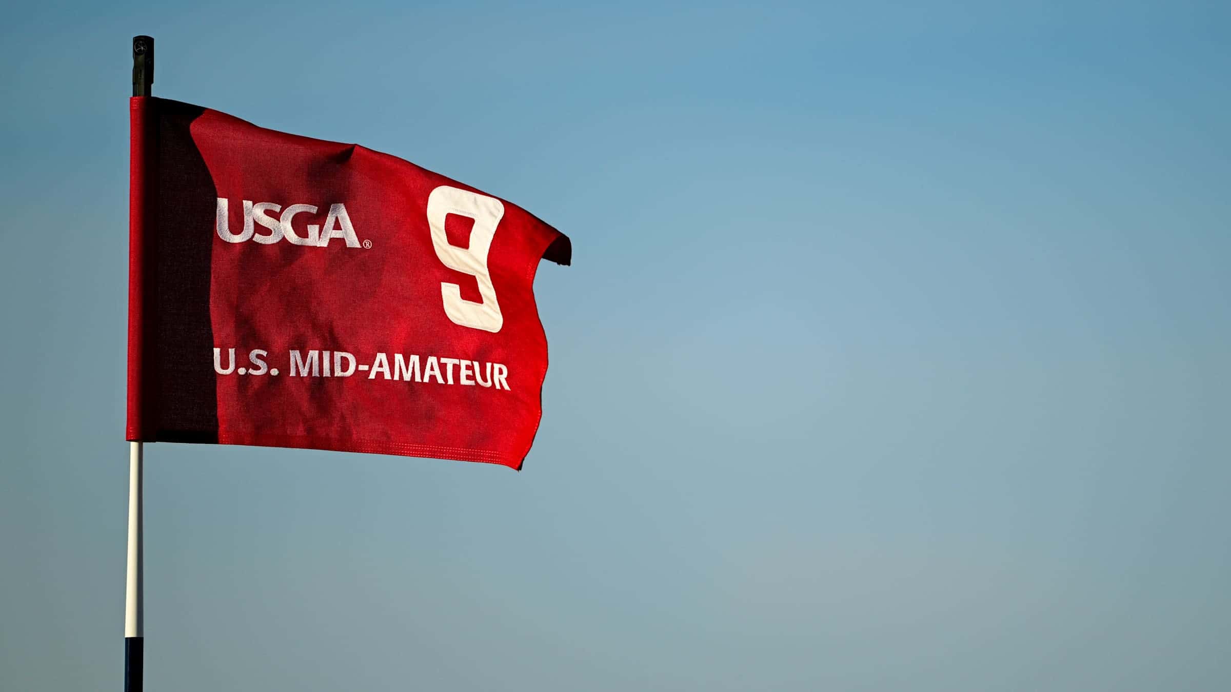 A U.S. Mid-Amateur hole flag at The Lido at Sand Valley, where seven of the eight quarterfinalists in 2026 had played professional golf.