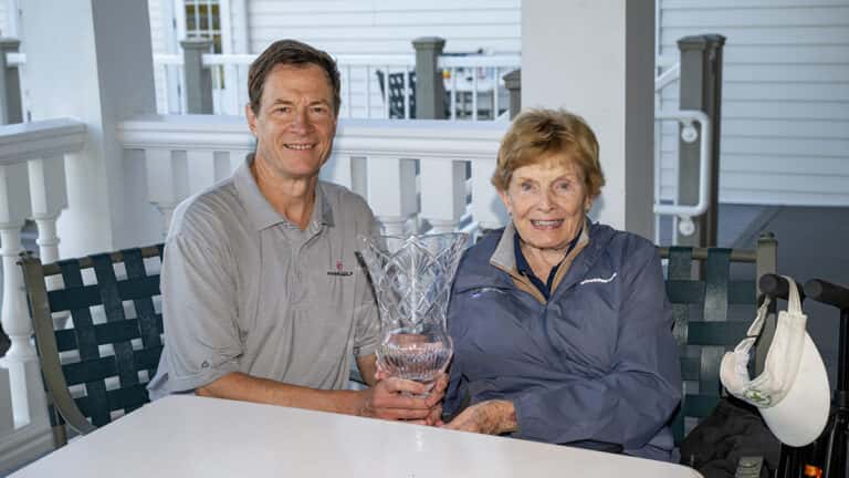 John McNeill holds the trophy with his mother Mary on Wednesday at Country Club of Pittsfield