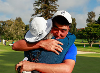 Doug Ghim hugs his mother after winning his match against Connor Syme
