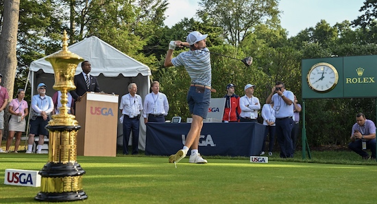 2022 U.S. Amateur champion Sam Bennett tees off with the <br>Havemeyer trophy in the foreground